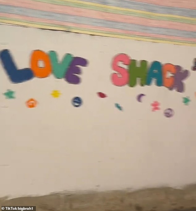 The content creator showed the small white door, which locked from the inside, with the words 'Love Shack' scrawled on one of the walls