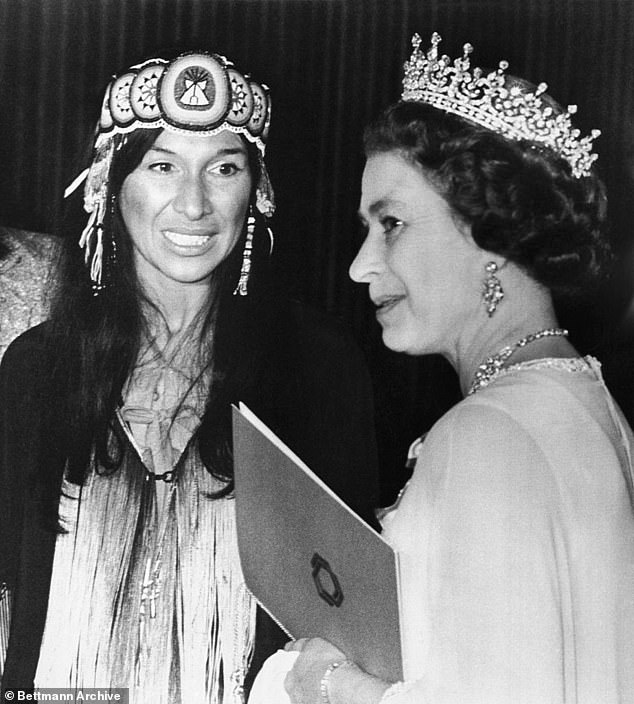 Allegations that she was born in Massachusetts to a white family and not, as she claimed, on an Indian reservation, were made on CBC's The Fifth Estate.  Pictured: Saint-Marie with Queen Elizabeth in 1977 at the National Arts Center in Ottawa