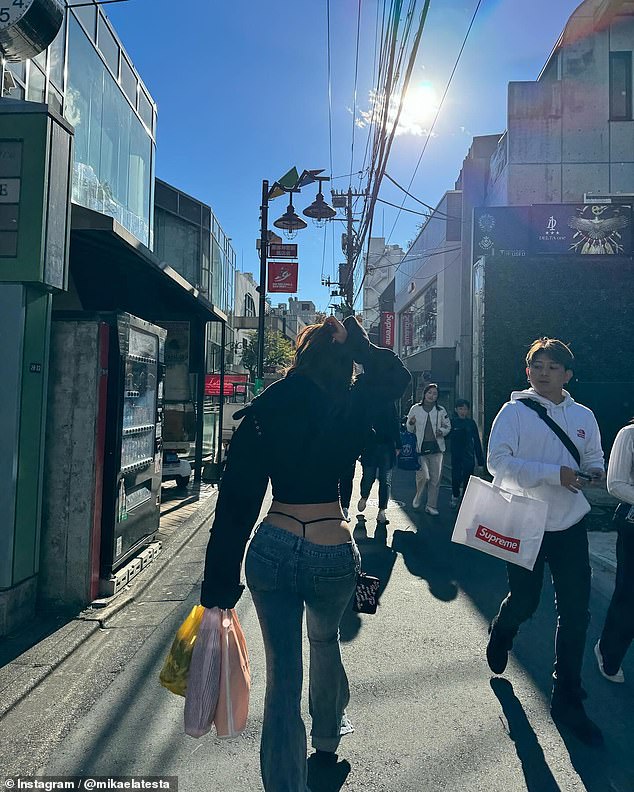 The 24-year-old strolled the streets of the bustling city in low-cut jeans that left her G-string visible