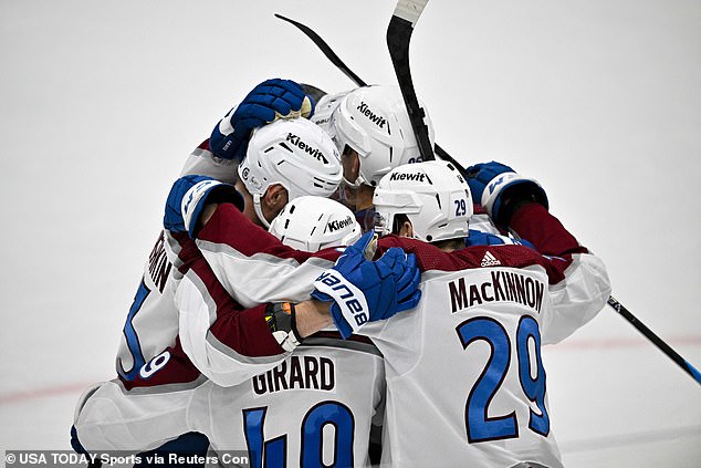 Girard (below, wearing 40) celebrates with his teammates during this week's game against Dallas