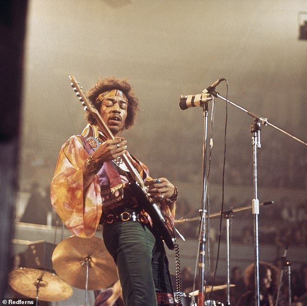 Jimi Hendrix performs live on stage playing a black Fender Stratocaster guitar with The Jimi Hendrix Experience at the Royal Albert Hall in London on February 24, 1969