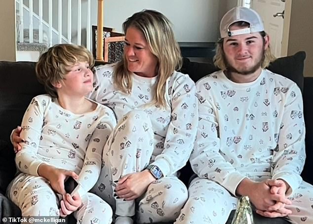 The mother-of-two is pictured in matching white Christmas pajamas with her two sons