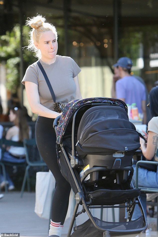 Sunny walk: She wore her newly dyed blonde locks in a loose bun for the sunny walk