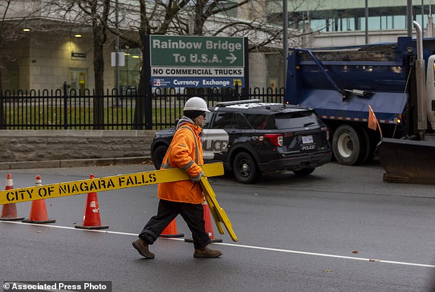 Workers block the entrance to the Rainbow Bridge border crossing between the U.S. and Canada, Wednesday, Nov. 22, 2023, in Niagara Falls, Ontario