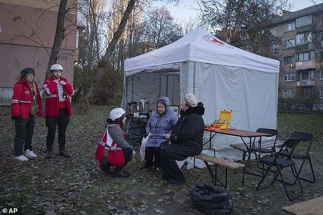 Paramedics provide psychological assistance to residents of a damaged apartment complex