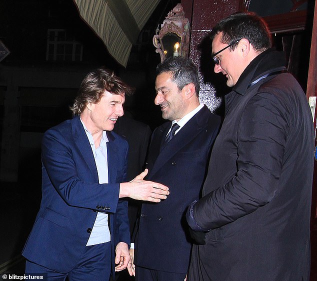 Friendly: The star looked cheerful as he shook hands with the establishment's manager and doormen