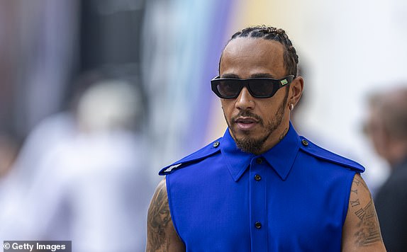 ABU DHABI, UNITED ARAB EMIRATES - NOVEMBER 24: Lewis Hamilton of Great Britain and Mercedes walk in the Paddock during previews ahead of the Abu Dhabi F1 Grand Prix at Yas Marina Circuit on November 23, 2023 in Abu Dhabi, United Arab Emirates.  (Photo by Edmund So/Eurasia Sport Images/Getty Images)