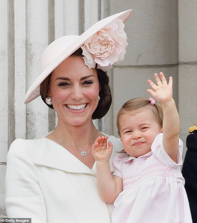 Catherine, Duchess of Cambridge and Princess Charlotte of Cambridge stand on the balcony of Buckingham Palace for Trooping the Color in 2016