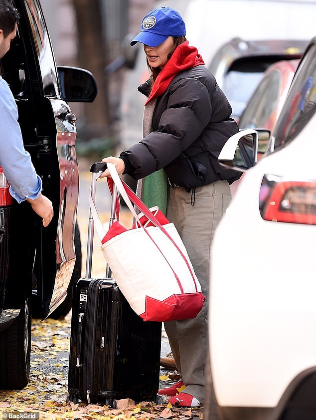 On the road: And on Saturday, Emily was seen again leaving her New York apartment as she loaded up a sleek vehicle with a suitcase and a tote bag