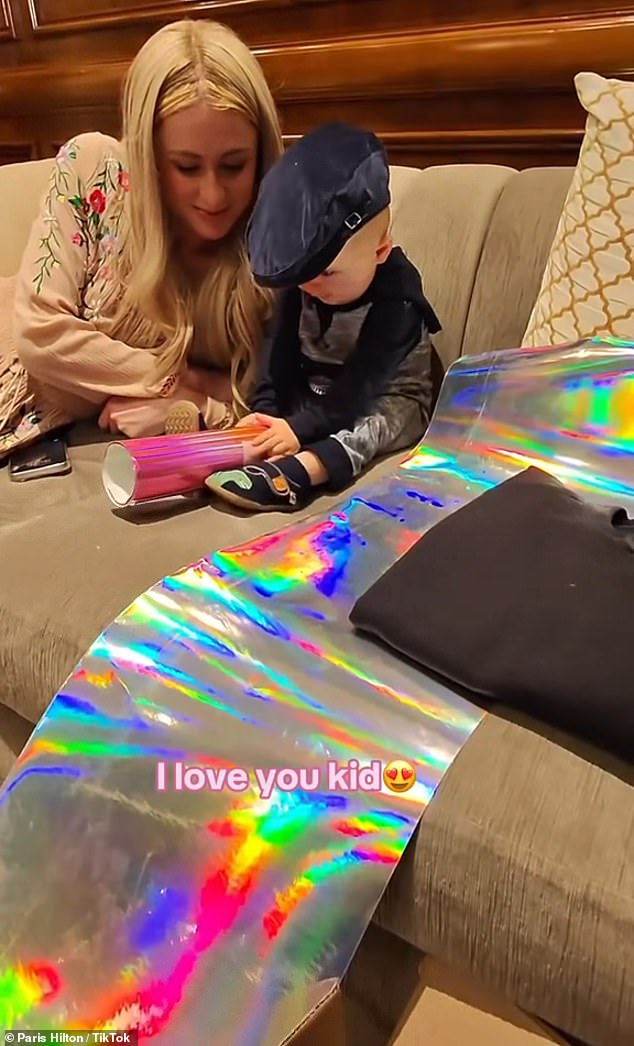 Family: The mother of two sat next to her toddler on the couch while dad filmed the interaction