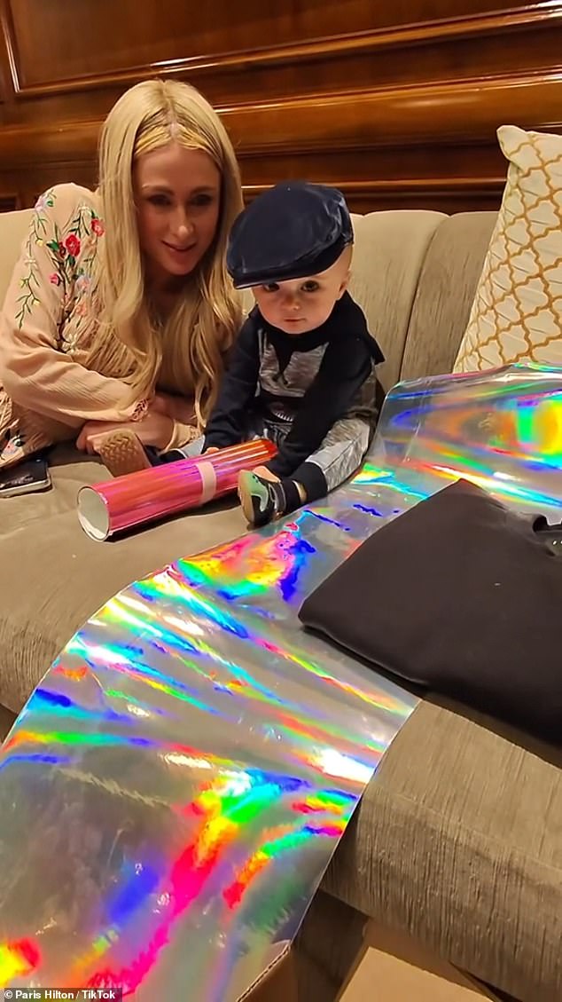 Playtime: Phoenix was alternately interested in what his father was saying and otherwise absorbed by the iridescent and pink rolls of paper he played with