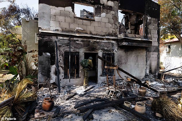 Aftermath: IDF soldiers search the remains of Kibbutz Be'eri in the days after the October 7 attack in which Hamas killed at least 130 people