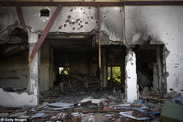 'I imagine they were shot and Hamas set the house on fire': Gavin Heller has spoken of his devastation at discovering his children were killed in the attack.  In the photo: a destroyed house in Kibbutz Be'eri