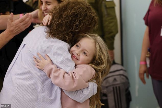 Emilia Aloni, five, released with her mother Danielle, 44, pictured hugging her grandmother