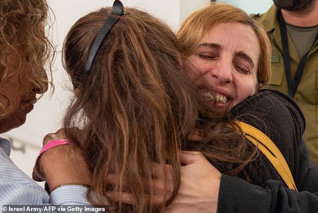 Daniele Aloni hugs members of her family after her release from Hamas and arrival in Israel