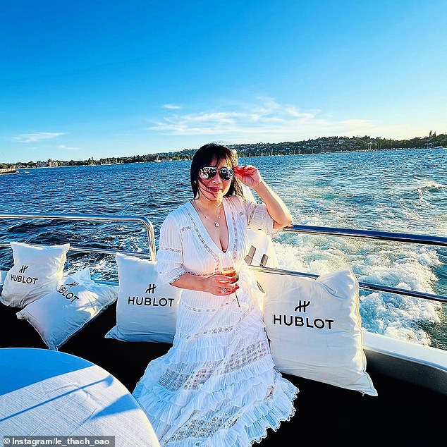 Ms. Thach poses on a boat during a water cruise