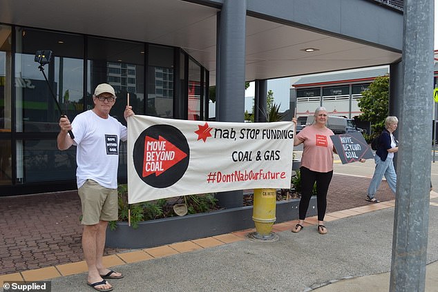 Mr Russell (pictured left) attends a protest against NAB's funding of new thermal coal mines earlier this year