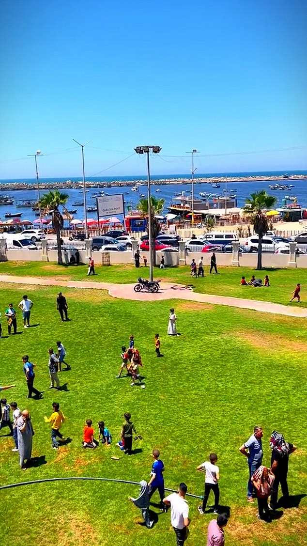 In one clip, children and their parents can be seen soaking up the sun as they gather in a seaside park