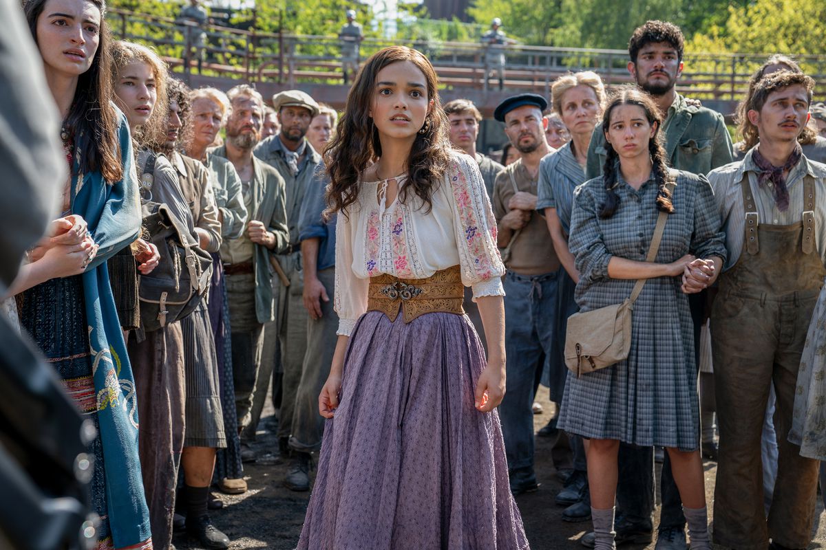 Lucy Gray looks shocked as she walks forward through the crowd