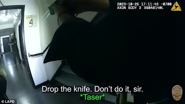 Officers ask the man to drop his knife while holding it in front of his stomach