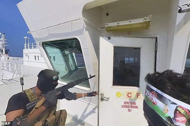 The Houthi rebels approached the bridge with weapons drawn, while crew members on the bridge held up their hands in surrender