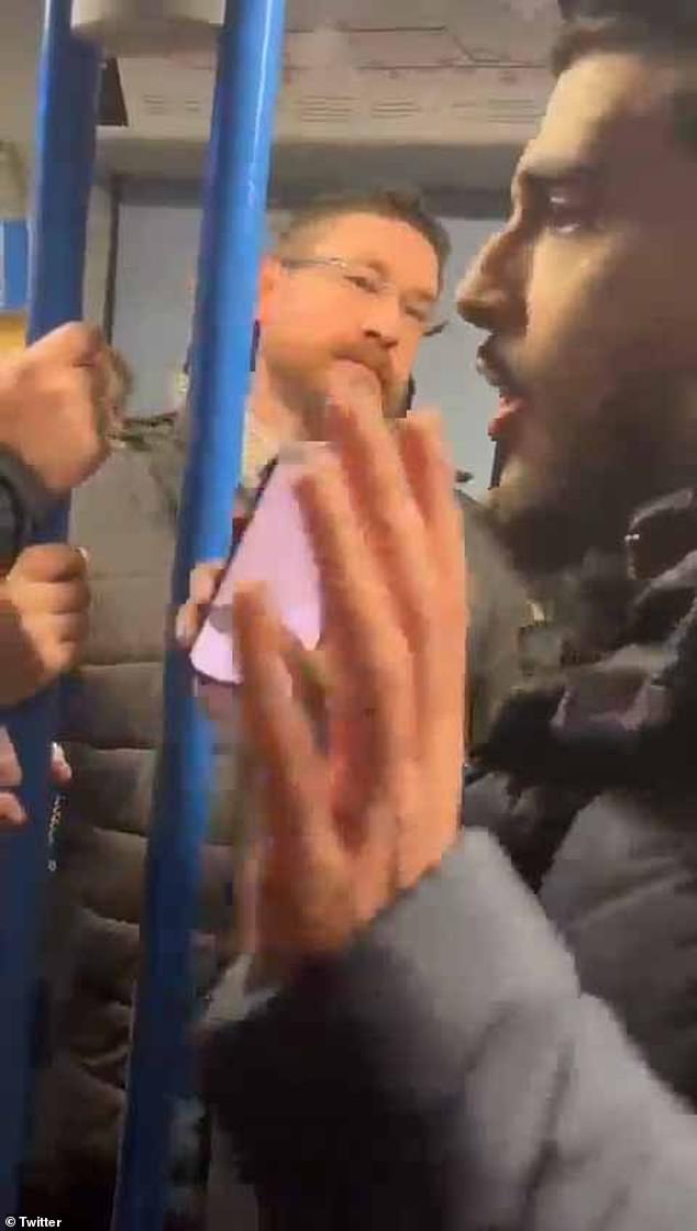 The video shows an argument breaking out between two men on a train, during which the Palestinian activist threatens to 'hit the pro-Israel supporter on the head'.