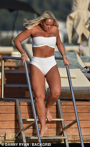 Wow: the beauty - who was size 18, now 10, showcased her toned figure in the chic white two-piece suit