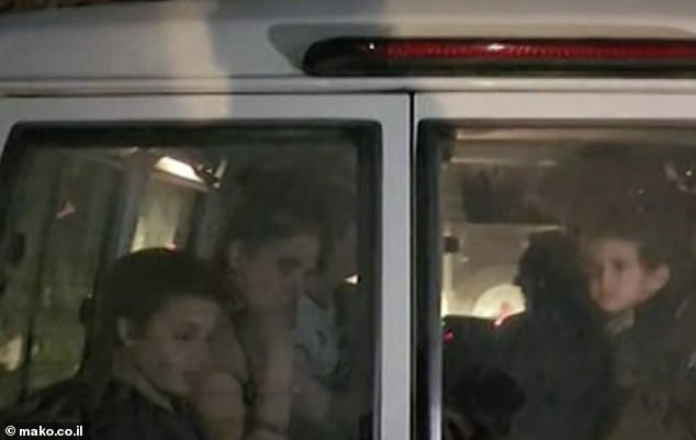 Abigail's first photo since her release: seen in a Red Cross ambulance (right) after being released by Hamas as the first American to be freed