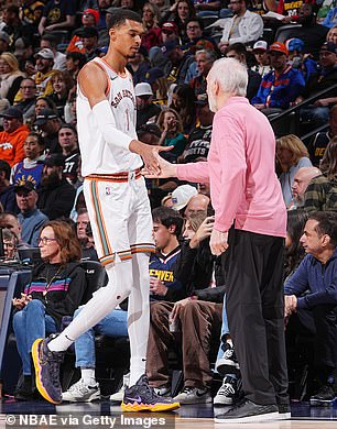 Victor Wembanyama greets Gregg Popovich of the San Antonio Spurs