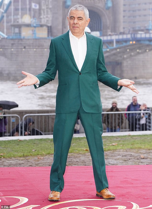 Legend: Rowan Atkinson opted for a striking green suit as he posed for photos at the Wonka photocall