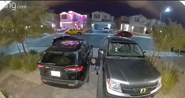 In the viral clip, an intruder hides between Strickland's two trucks parked in his driveway