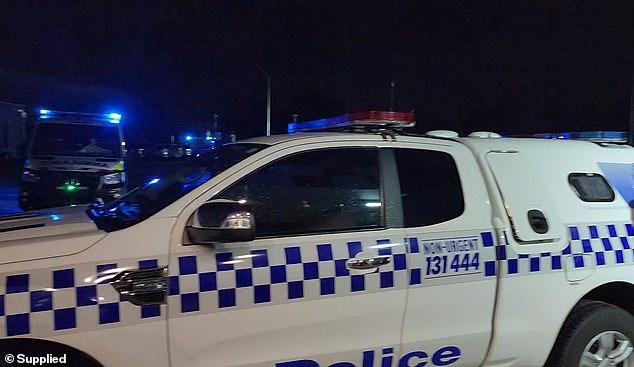 A police car arrives on the scene after the young man was stabbed