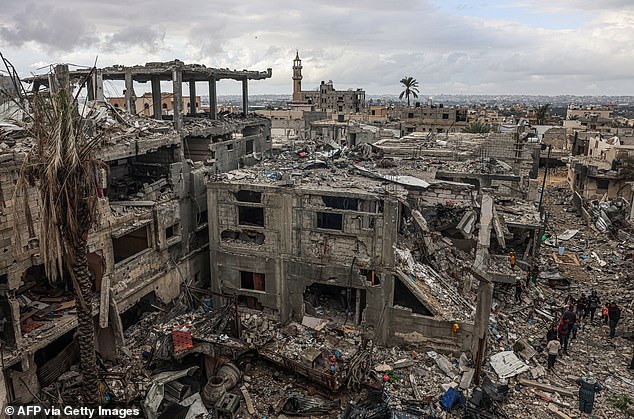 Palestinians inspect the destruction caused by Israeli attacks on their homes in the village of Khuzaa, east of Khan Yunis near the border fence between Israel and the southern Gaza Strip on November 27