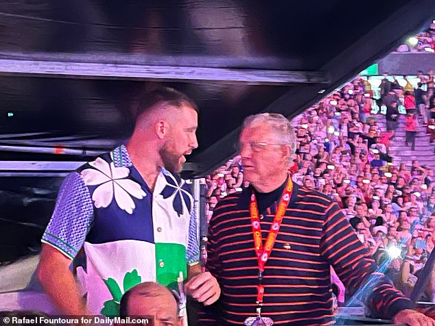 Kelce was spotted chatting with the pop superstar's father, Scott (right)