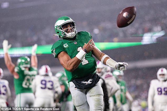 Jalen Hurts (1) throws the ball to fans after scoring a touchdown in the first quarter on Sunday