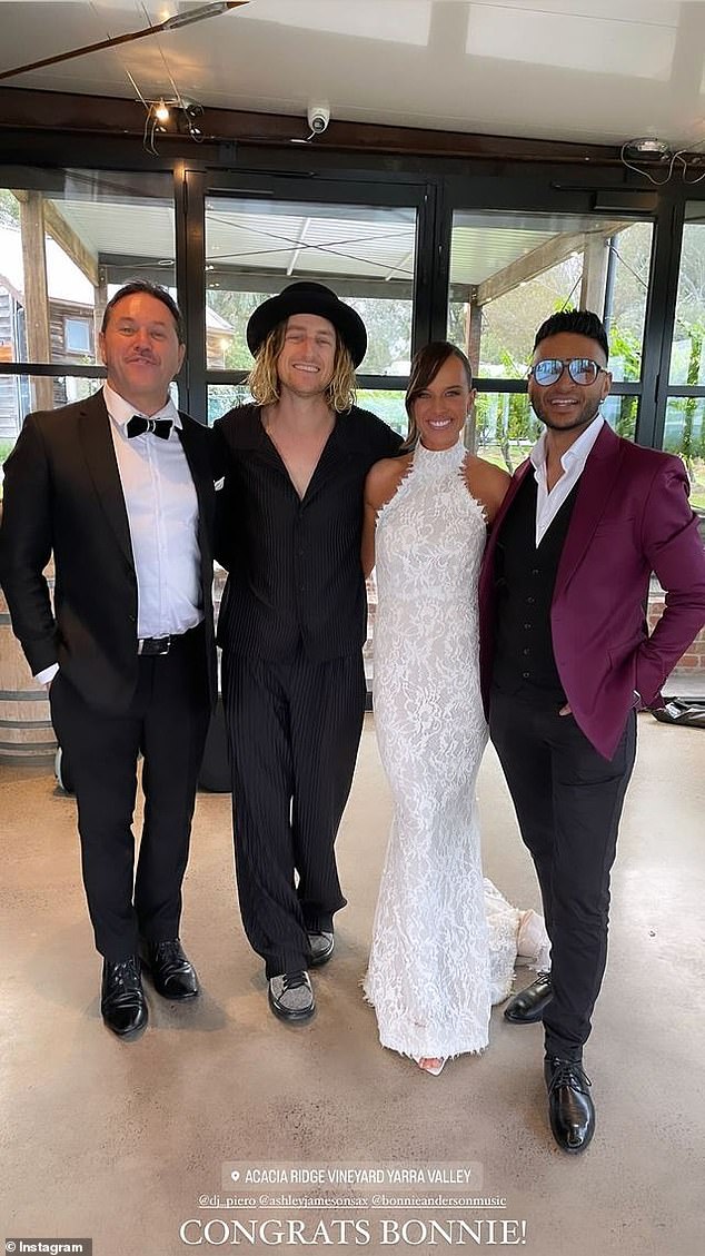 The bride posed next to her fashionable guests