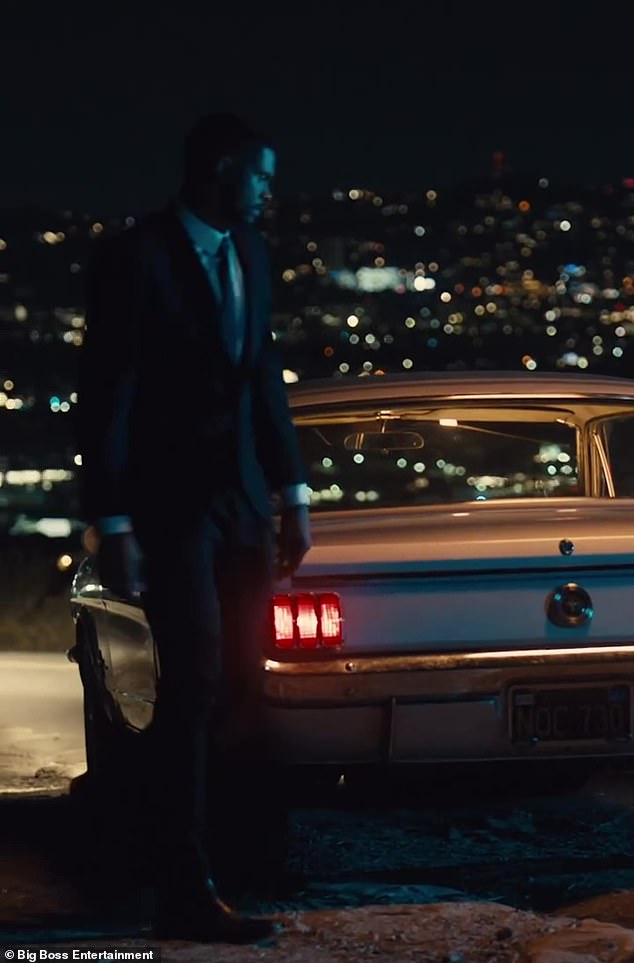 Left for dead: A man in a suit and tie takes her out of the trunk of a vintage Mustang and dumps her on the ground at the beginning of the clip