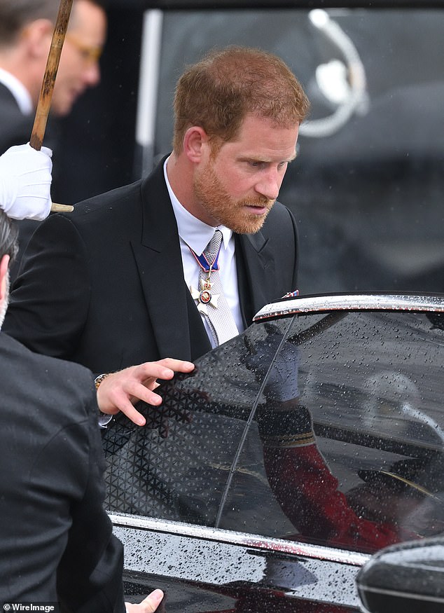 Prince Harry leaves Westminster Abbey after the coronation.  He went straight to the airport to catch a flight back to the US