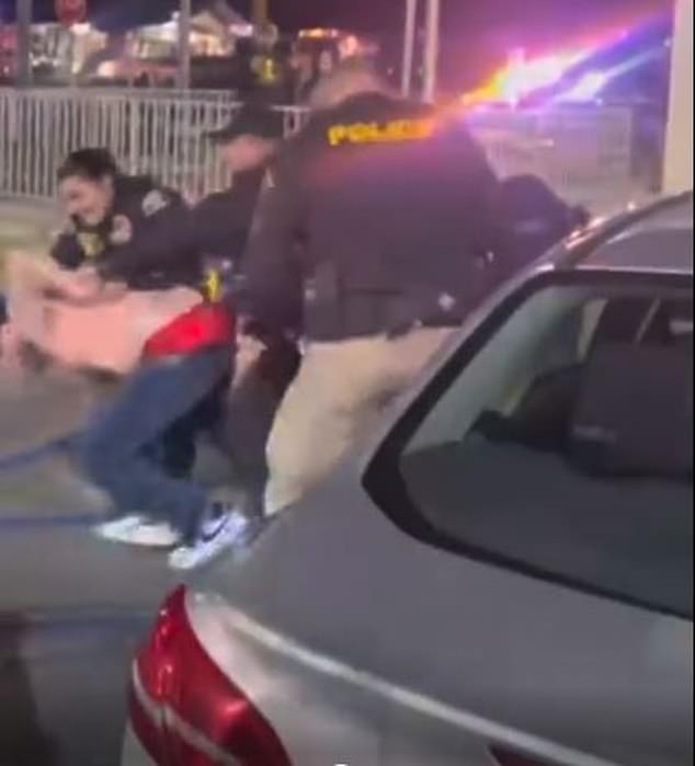 Outside, four other unnamed police officers ran to the scene and began beating the male customer with sticks while pinning the woman to the ground.