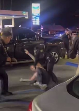 A female officer ran over to help another officer restrain the male customer, who writhed in police custody after they started hitting him with sticks