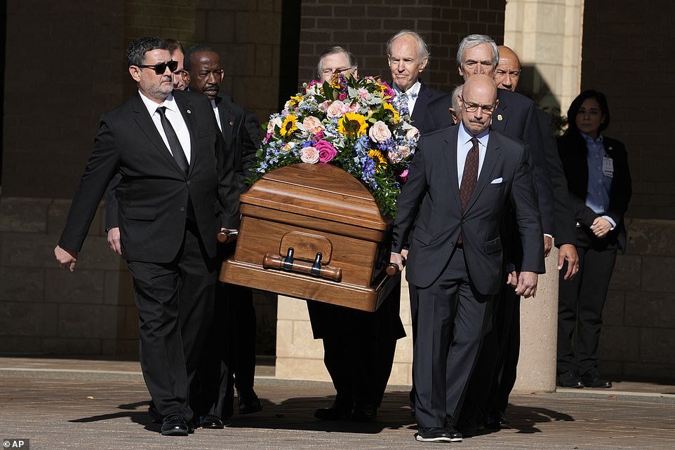 Family members and current and former U.S. Secret Service agents assigned to Rosalynn's department gathered Monday morning as her casket left Phoebe Sumter Medical Center in Americus, Georgia, where wreaths were laid for the former first lady.  Secret Service agents carried her casket and walked past the motorcade of the hearse carrying her body as it left Georgia Southwestern State University's Rosalynn Carter Health and Human Sciences Complex.