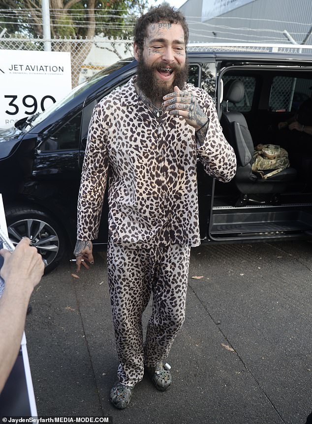 The rapper, real name Austin Richard Post, opted for chic leopard print pajamas upon his arrival in Sydney and teamed them with a pair of camouflage Crocs.