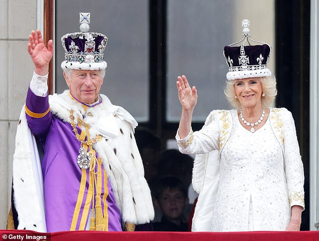 Big day: King Charles III and Queen Camilla waved from a balcony at Buckingham Palace at the coronation