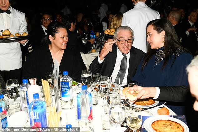 Catching up: De Niro was spotted chatting with his co-star Lily Gladstone, who won one of the top acting awards for The Unknown Country, while sitting with his girlfriend Tiffany Chen