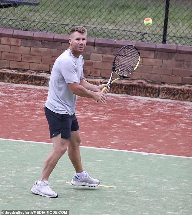 David, 37, sported a stylish athleisure look in a gray Kathmandu T-shirt which he paired with black Nike shorts and white sneakers