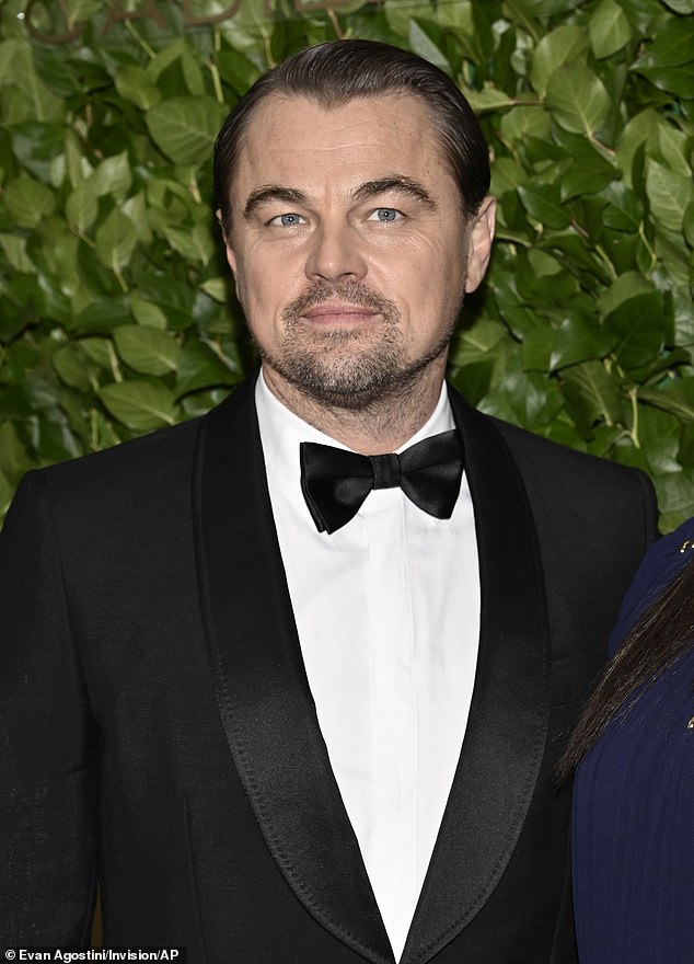 Brave display: The Titanic star looked dapper in a classic black tuxedo with a white button-down and a satin bow tie