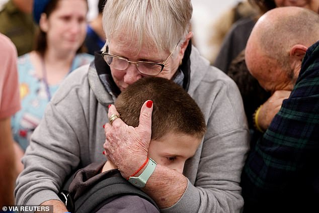 Tal Goldstein-Almog, 9, (pictured) was cradled by his loved ones after he and the other hostages returned to Israel