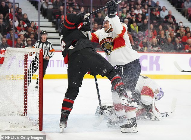 Dmitry Kulikov of the Florida Panthers checks on Ottawa's Brady Tkachuk in the third