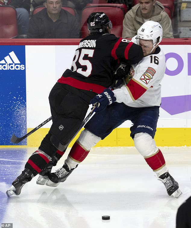 Senators defenseman Jake Sanderson (85) collides with Panthers center Aleksander Barkov