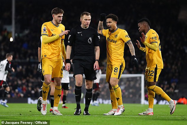 Wolves players argue with referee Michael Salisbury after conceding a penalty against Fulham - a decision that PGMOL later agreed was incorrect following their controversial 3-2 defeat